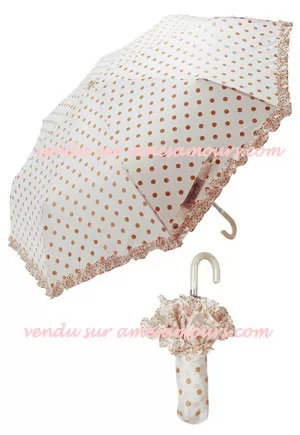 Parapluie pliable crème à pois orangés dorés. Insolite et pratique, ce parapluie pliable est un véritable accessoire de mode. Notez que les pois sont de coloris orange et pailletés. Diamètre 98cm.